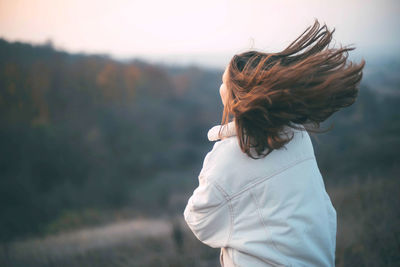 Rear view of woman standing outdoors