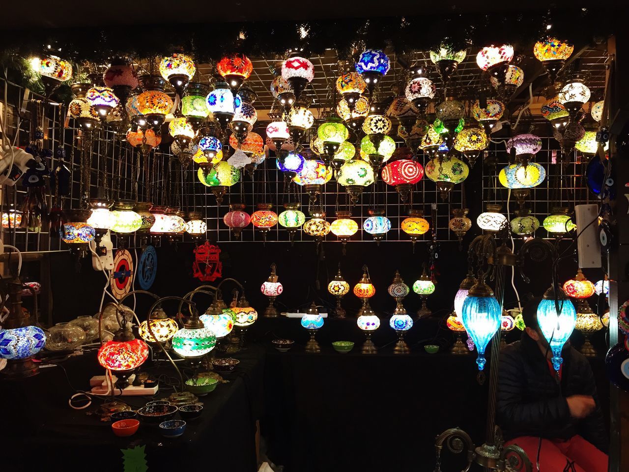 ILLUMINATED LANTERNS HANGING IN STORE FOR SALE AT NIGHT