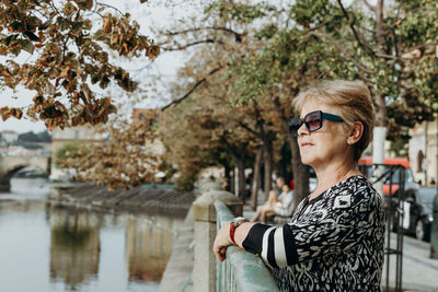 Senior woman enjoying the beauty of the river on a summer day.