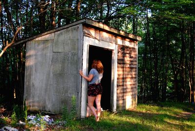 Woman standing at barn entrance