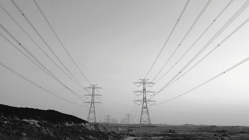 Low angle view of electricity pylon against sky