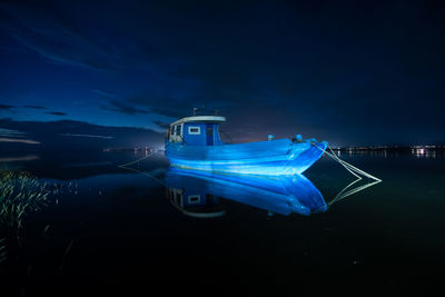 Blue boat at high tide during night
