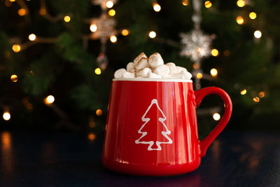 Close-up of coffee cup on christmas tree