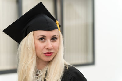 Midsection of woman wearing graduation gown