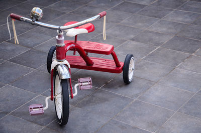 High angle view of red tricycle on tiled floor