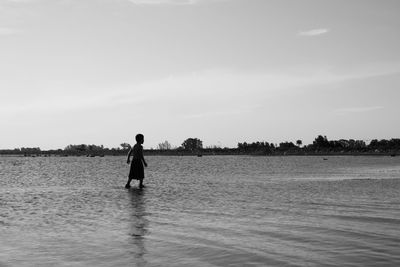 Portrait of boy walking in the sea