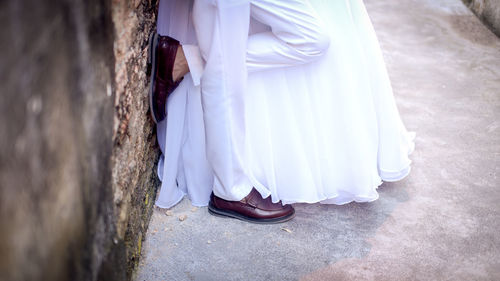 Low section of couple standing on floor