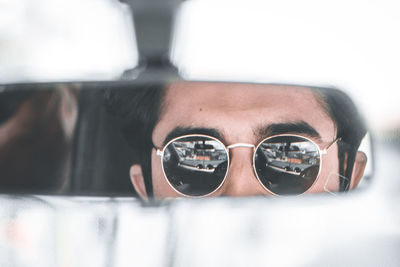 Close-up portrait of young man wearing sunglasses