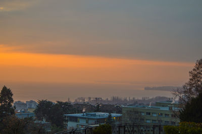 High angle view of buildings against sky at sunset