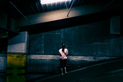 Full length of woman standing in illuminated room