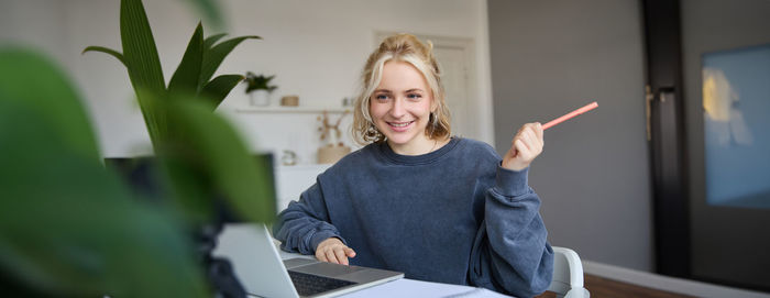 Portrait of young woman using mobile phone