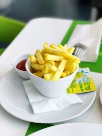 Close-up of french fries with sauce in plate on table