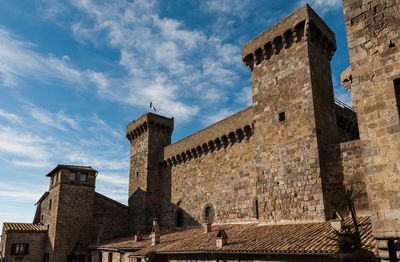 Low angle view of historic building against cloudy sky
