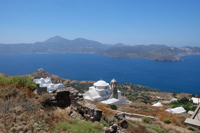 High angle view of sea and mountains against clear sky