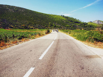 Empty road with trees in background