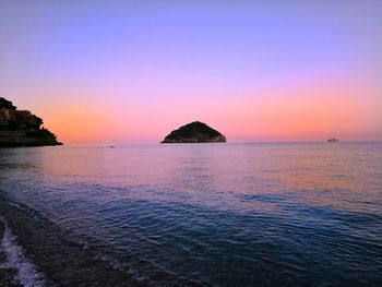 Scenic view of sea against romantic sky at sunset