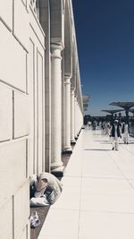 People relaxing at observation point against sky