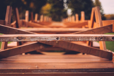 Row of upside down picnic tables stacks at park