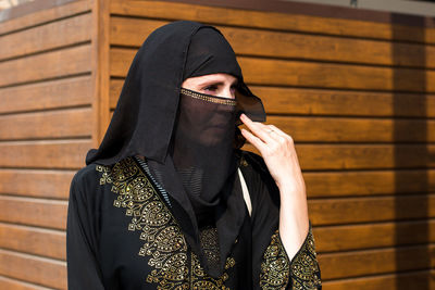 Muslim woman carefully looks into the distance bright sunny day.