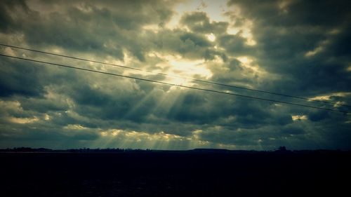 Low angle view of landscape against cloudy sky