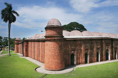 View of temple on field against sky