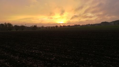 Scenic view of field against sky during sunset