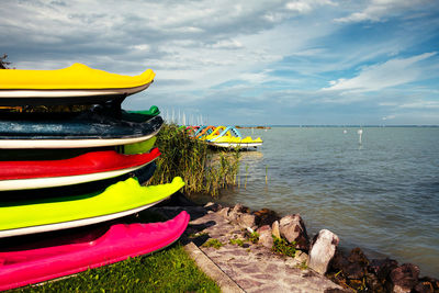 Boats moored on beach against sky