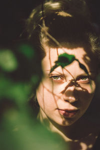 Close-up portrait of young woman during sunny day