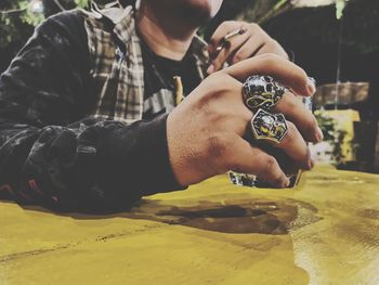 Close-up of man holding camera against blurred background