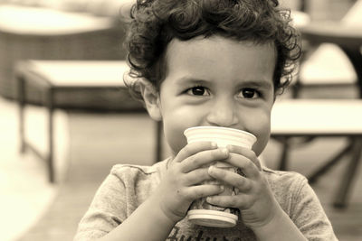 Portrait of a boy drinking coffee
