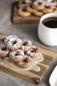 High angle view of coffee with sweet food on table