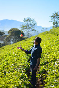 A woman playing rubik in a tea garden