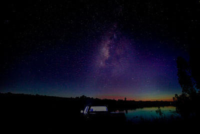 Scenic view of lake against star field at night