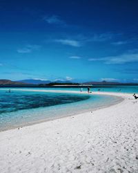 View of beach against blue sky