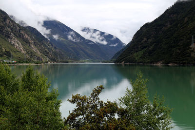 Scenic view of lake and mountains against sky