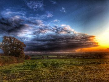 Scenic view of field against sky during sunset