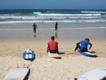 Rear view of people on beach