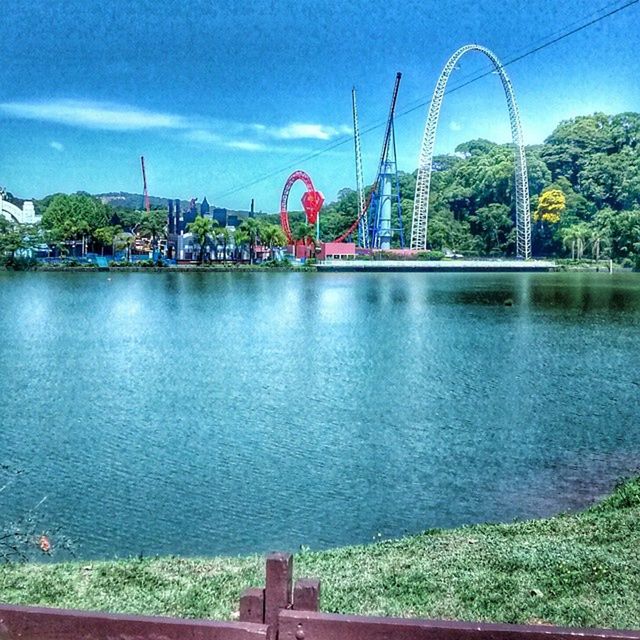 water, built structure, architecture, sky, river, bridge - man made structure, connection, blue, tree, cloud - sky, building exterior, waterfront, city, cloud, railing, suspension bridge, lake, bridge, outdoors, day