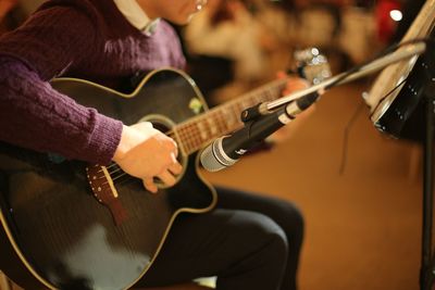 Cropped image of man playing guitar