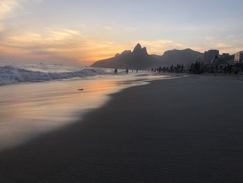 Scenic view of beach against sky during sunset