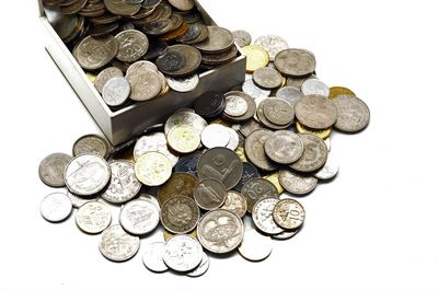 High angle view of coins on white background