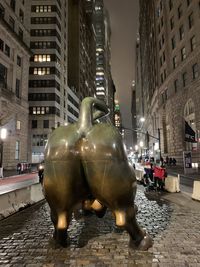 View of statue against buildings in city