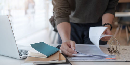 Midsection of woman working on table