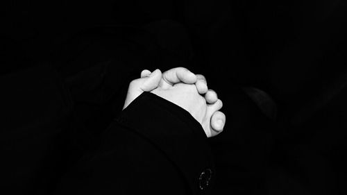 Close-up of hand against black background