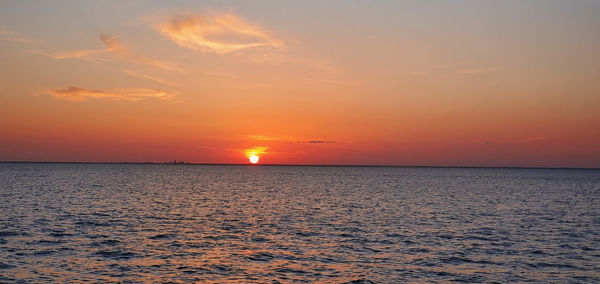 Scenic view of sea against romantic sky at sunset