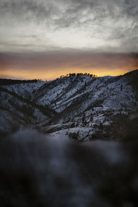 Scenic view of snowcapped mountains against sky during sunset