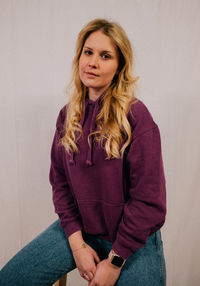 Portrait of young woman sitting at home