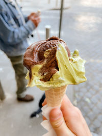 Cropped hand holding ice cream cone