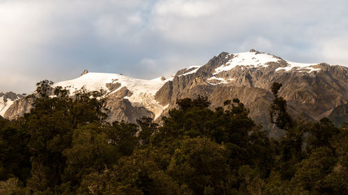 Scenic view of mountains against cloudy sky