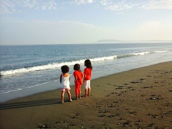 Rear view of women on beach